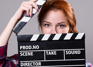 Beautiful Red-haired Woman Holding A Movie Clapper, Isolated Ove