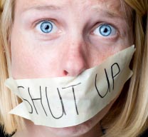 Girl with "shut up" tape over her mouth